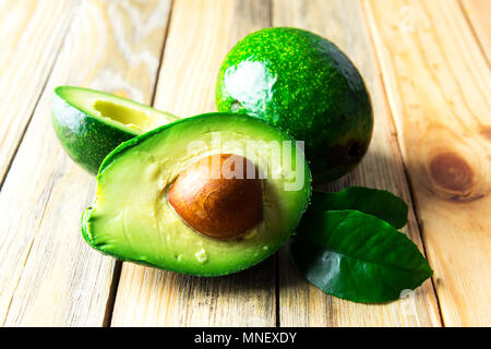 Fresh avocado fruit on a wooden board Stock Photo