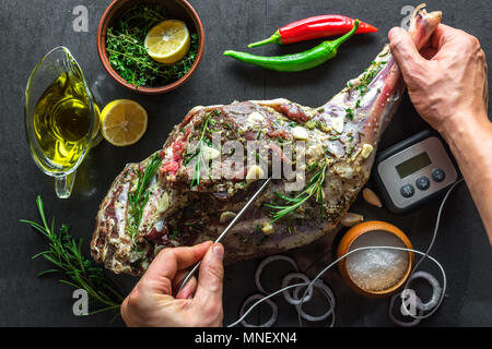 Raw lamb leg, marinated with herbs Stock Photo