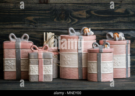 Pink, gray ceramic jars set on blue background Stock Photo