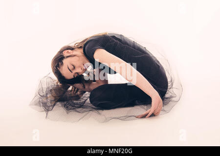 Female dancer in tights with black tulle sitting on the floor, Istanbul Stock Photo