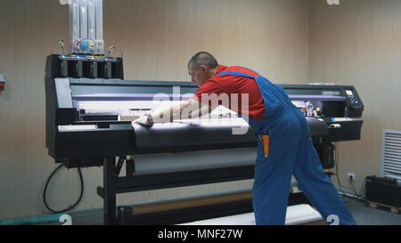 Man in typography working on the printing press Stock Photo