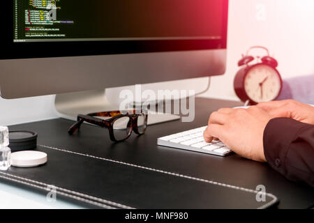 closeup of programmer hand on white keyboard while working Stock Photo