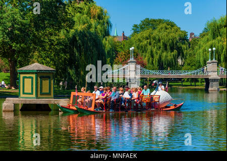 Boston, Massachusetts, USA - September 12, 2016:  Swan Boats have been in operation since 1877 in Boston's Public Garden.  Pedal powered by the driver Stock Photo