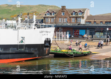 cyclists disembarking Loch Shira ferry in Largs, Scotland returning from Millport Great Cumbrae Stock Photo