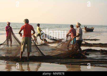 Indian Fishermen with Net on Beach, Colva, India Stock Photo