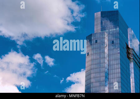 Boston, Massachusetts, USA - September 14, 2016:The top half of the Millennium Tower reflects the blue sky and white clouds. Stock Photo