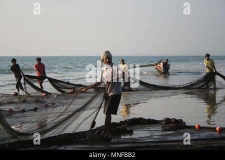 Indian Fishermen with Net on Beach, Colva, India Stock Photo