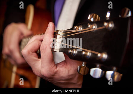 Men's hands play the guitar Stock Photo