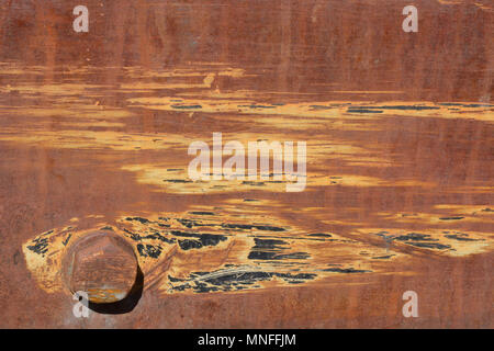 Rusted and scratched old vintage metal machine with nut and bolt Stock Photo