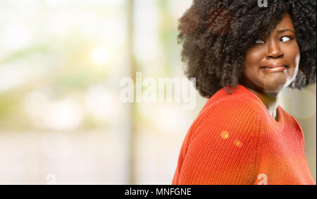 Beautiful african woman feeling disgusted with tongue out, outdoor Stock Photo