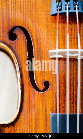 Extreme macro on F hole in violin belly / body. Vertical full frame top view Stock Photo