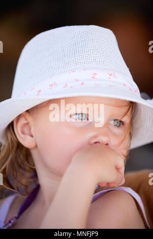 Portrait of adorable little girl wearing white hat Stock Photo