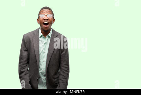 African black man wearing jacket stressful, terrified in panic, shouting exasperated and frustrated. Unpleasant gesture. Annoying work drives me crazy Stock Photo