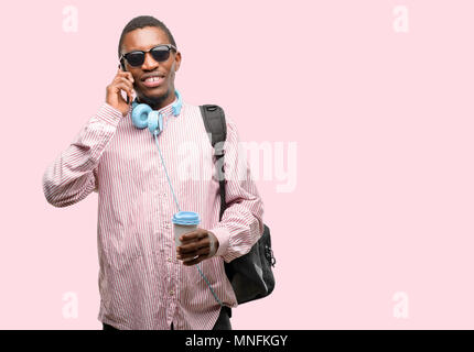 African black man student happy talking using a smartphone mobile phone Stock Photo