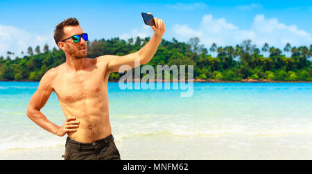 People doing selfie on phone on tropical nature background with copy space text. Concept mobile photo and social media with free space for copy space Stock Photo