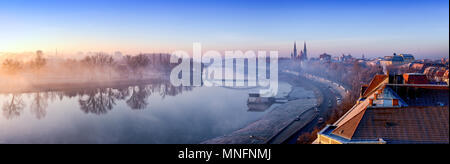 Szeged panorama with Tisza river and Votive Church visible in the back. Panoramic image at dusk with fog. HDR image. Stock Photo