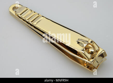 Closeup of nail clippers in gold color Stock Photo