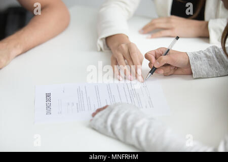 Wife signing divorce decree after break up decision Stock Photo