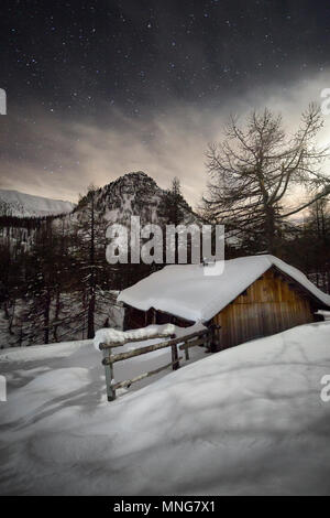 The mountains and refuge huts of Parc National Du Mercantour photographed at night. Stars shine bright in this amazing moonlight landscape. Stock Photo