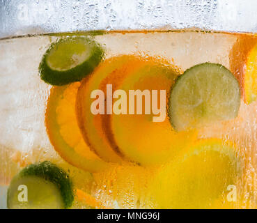 Orange and Lime Slices in Water Stock Photo