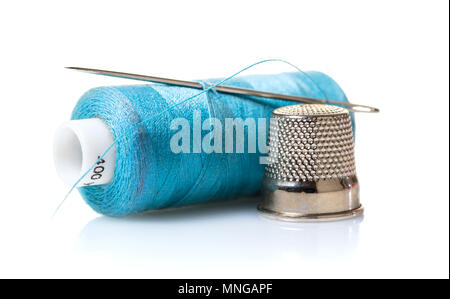 Thread with needle and thimble on white isolated background Stock Photo