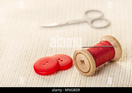 coils of colored thread on white knitted fabric Stock Photo