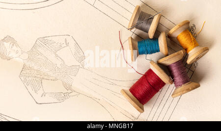 coils of colored threads on a background of paper pattern Stock Photo