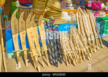 KYAIKTIYO, MYANMAR - FEBRUARY 16, 2018: The souvenir stall next to the Golden Rock Buddhist Temple offers wide range of hats and wooden replicas of me Stock Photo