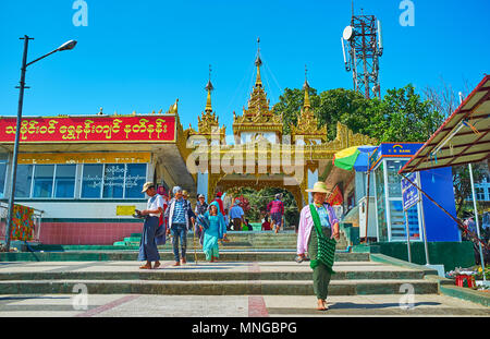 KYAIKTIYO, MYANMAR - FEBRUARY 16, 2018: The numerous Buddhist devotees visit the complex of Kyaiktiyo Pagoda, located on the mountain summit and conta Stock Photo