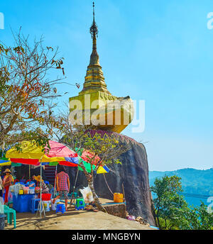 KYAIKTIYO, MYANMAR - FEBRUARY 16, 2018:   The Golden Rock complex is famous for the unique temples and stupas, located in mountains, some shrines are  Stock Photo