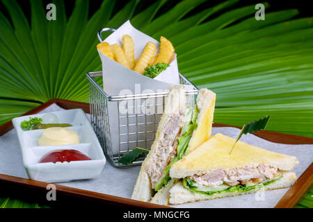 closeup photo of sandwich with tuna and vegetables on rye bread on wood background and Leaf background Stock Photo