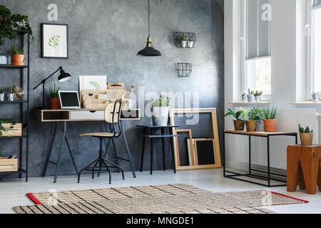 Room with modern decor, potted plants and wooden empty frames Stock Photo