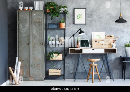 Study room interior with desk and industrial metal wardrobe Stock Photo