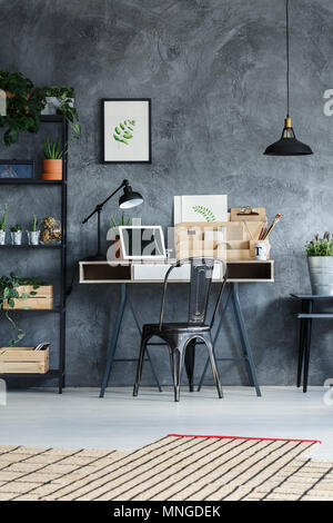 Wooden accents and botanical prints in workshop of creative artist Stock Photo