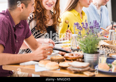 Lavender in metal bucket on table with healthy food during vegetarians dinner in restaurant Stock Photo