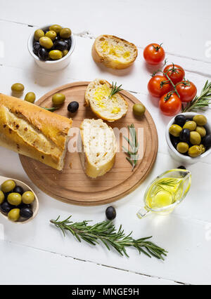 Black and green olives in wooden bowls on wood white background Stock Photo