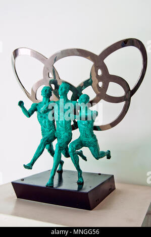 Olympic Games artwork depicting three runners in front of the Olympic symbol on display in the China Science and Technology Museum in Beijing, China. Stock Photo