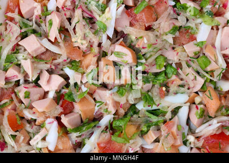 The leaves of fresh green vegetables, eggs , tomatoes  and  sausages finely chopped for spring  meat salad. Studio top view macro shot Stock Photo