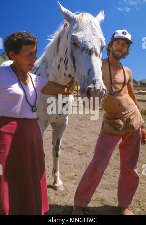 RAJNEESHPURAM, OREGON, USA - Rajneeshees, followers of religious cult leader Bhagwan Shree Rajneesh, and horse. 1982 Stock Photo