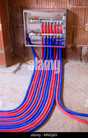 Heating kontrol panel and blue and red pipes Stock Photo