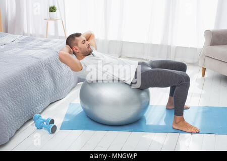 Handsome attractive man doing an exercise Stock Photo