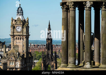 View of clocktower on Balmoral Hotel, Scott Monument and Dugald Stewart Monument in Edinburgh, Scotland, UK. Stock Photo