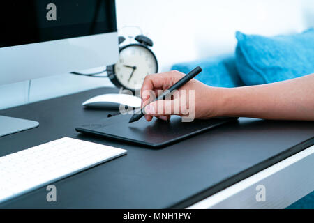 The busy graphic designer working on computer by digital pen mouse Stock Photo