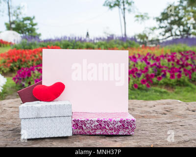 Red heart and paper card on rock retro background, total beautiful gift box, Stock Photo