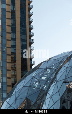 The Amazon company world headquarters in Seattle Washington afternoon sun, man silhouetted on balcony overlooking the Spheres and campus. Stock Photo