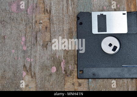 black floppy disk on wood board Stock Photo
