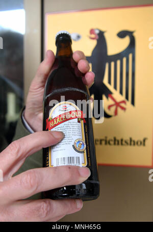 17 May 2018, Germany, Karlsruhe: A bottle of beer from the Clemens Haerle brewery featuring the word 'bekoemmlich' outside the German Federal Court of Justice. The German Federal Court of Justice (BGH), is the hearing the case of whether a small brewery is allowed to describe its beers as 'bekoemmlich'. Photo: Uli Deck/dpa Stock Photo