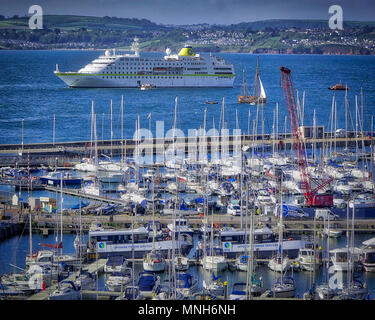 Torbay, UK . 17th May 2018. GB - DEVON: MS Hamburg arrival in Torbay with Torquay harbour in foreground. MS Hamburg is a 15,000-ton, 420 passenger, luxury cruise ship owned by the Conti Group and is now operated by Plantours Kreuzfahrten. UK 17. May 2018 Credit: nagelestock.com/Alamy Live News Stock Photo