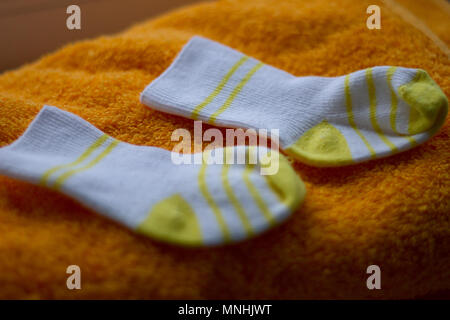 baby booties on towel Stock Photo