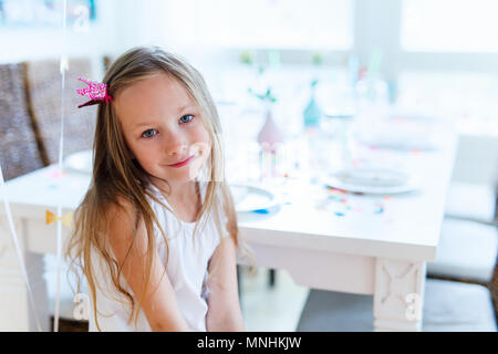 Adorable little girl with princess crown at kids birthday party Stock Photo